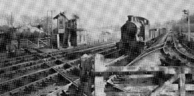 On the former TVR main line south of Taff's Well, an ex-GWR 0-6-2T hustles a load of coal empties across the ancient crossing of the Melingriffith Tramroad at Pentyrch in 1954 (R.J.Doran)